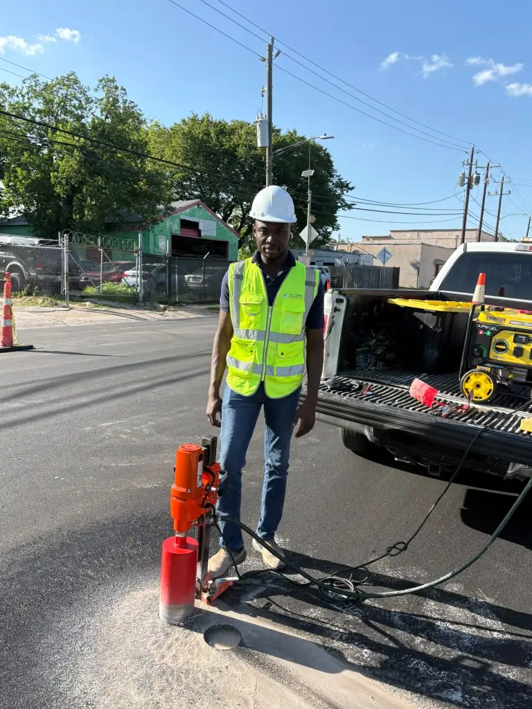 Technician with core drill rig on an asphalt roadway